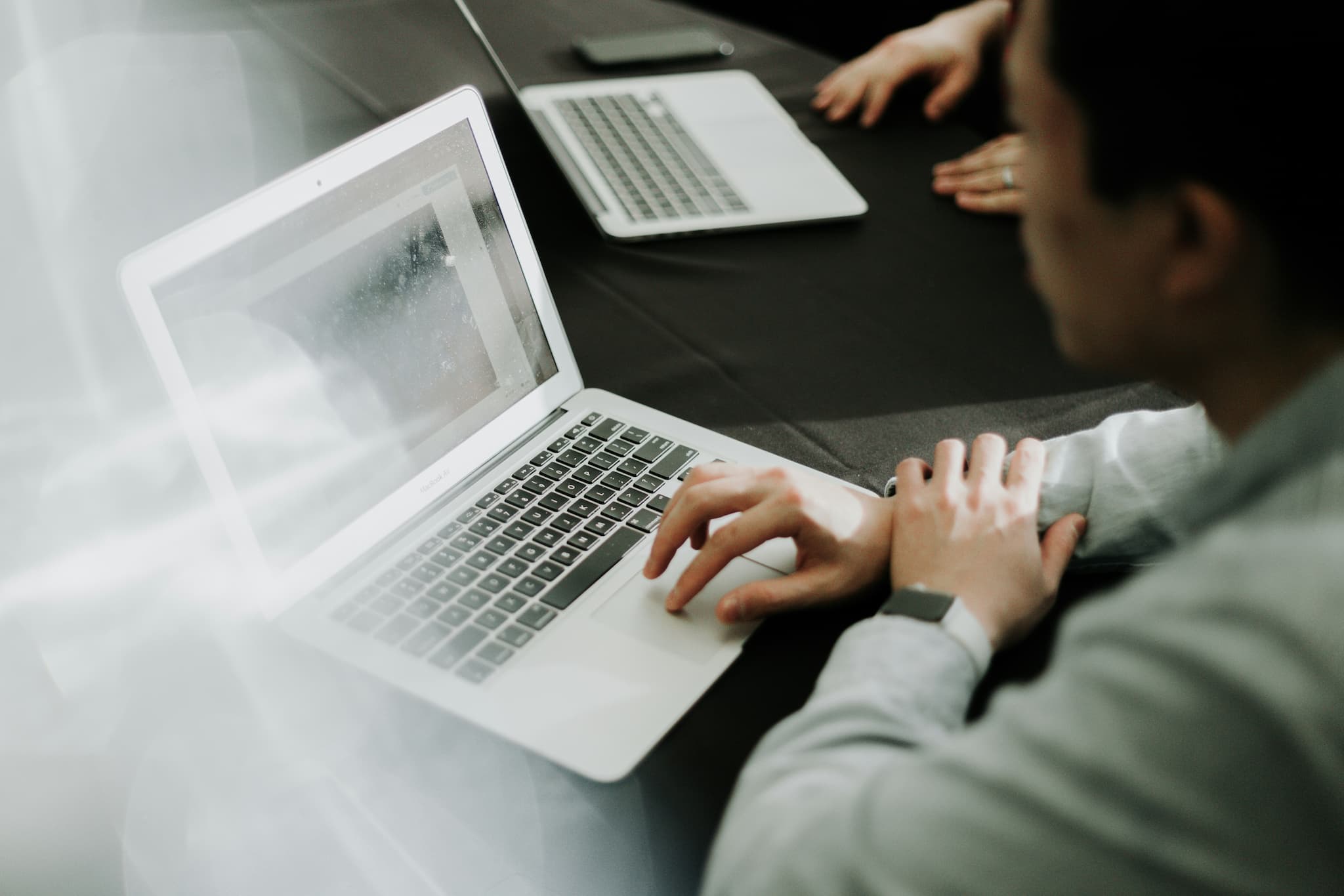 Person using a laptop to complete an online application